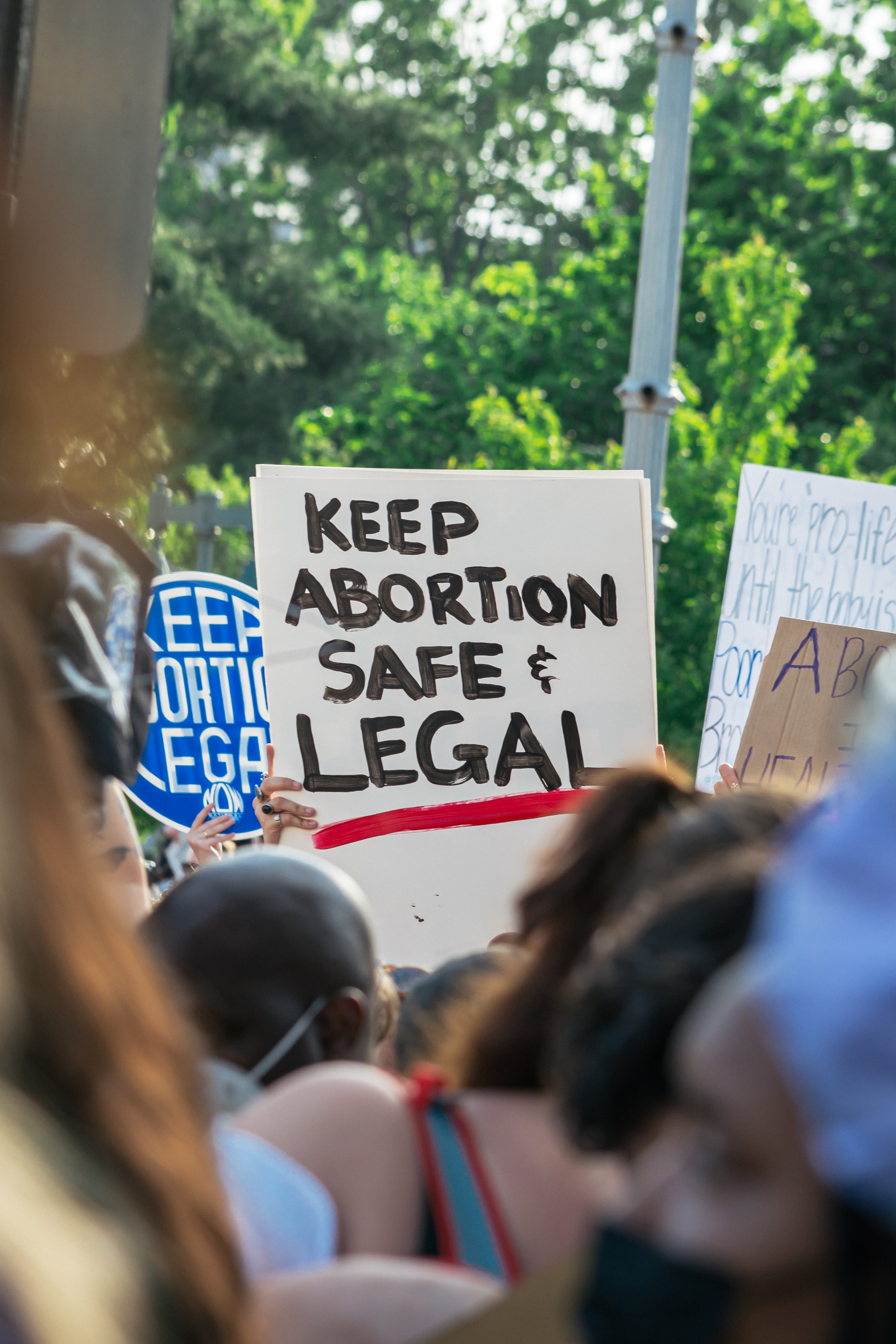 protest with sign saying "keep abortion legal"