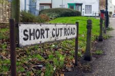 Street sign that reads "Short Cut Road."