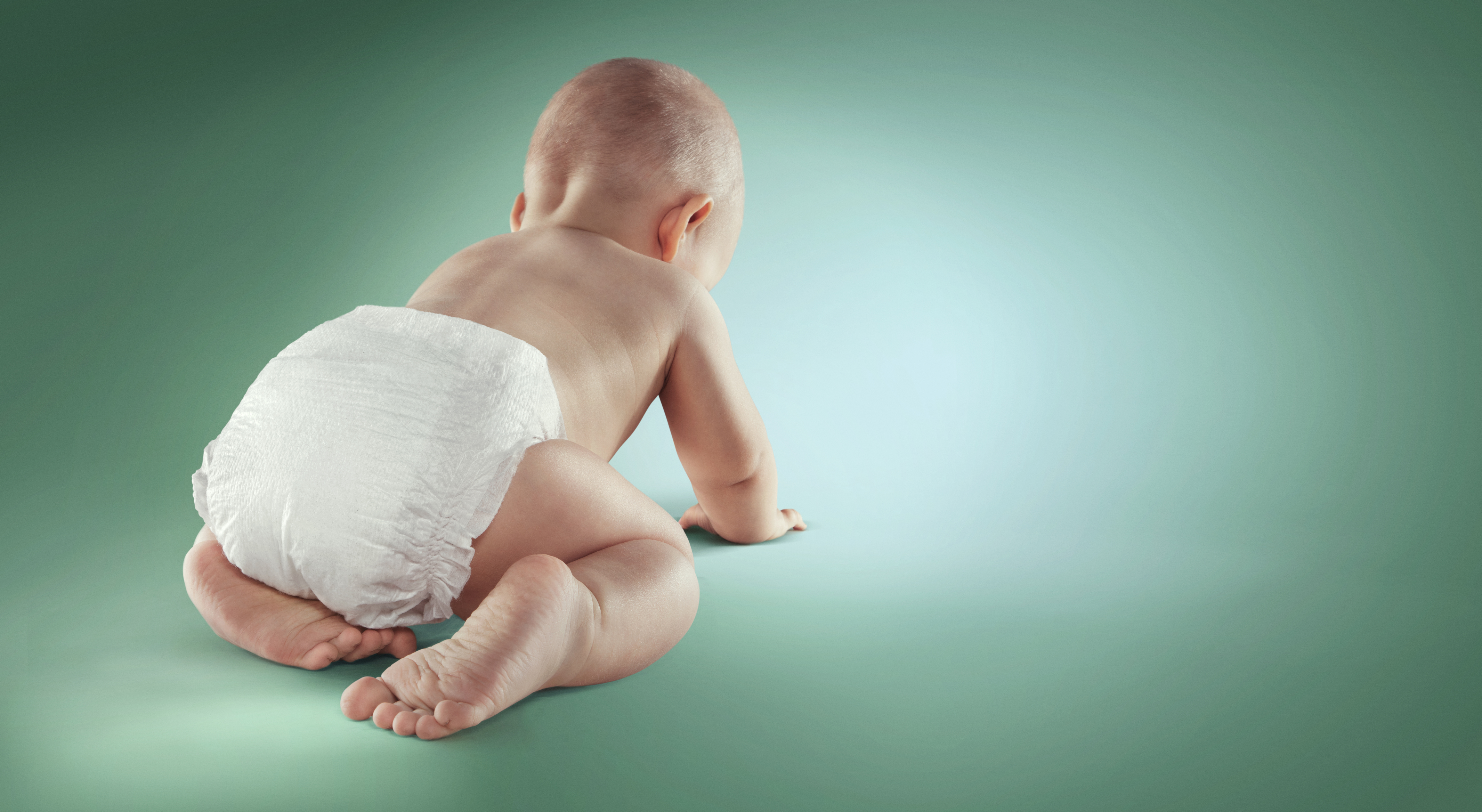 white baby crawling away from camera