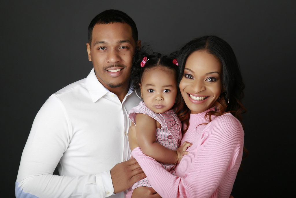 Two parents holding a baby