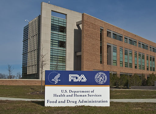 A building, with a sign in front reading "US Department of Health and Human Services Federal Regulation Administration."