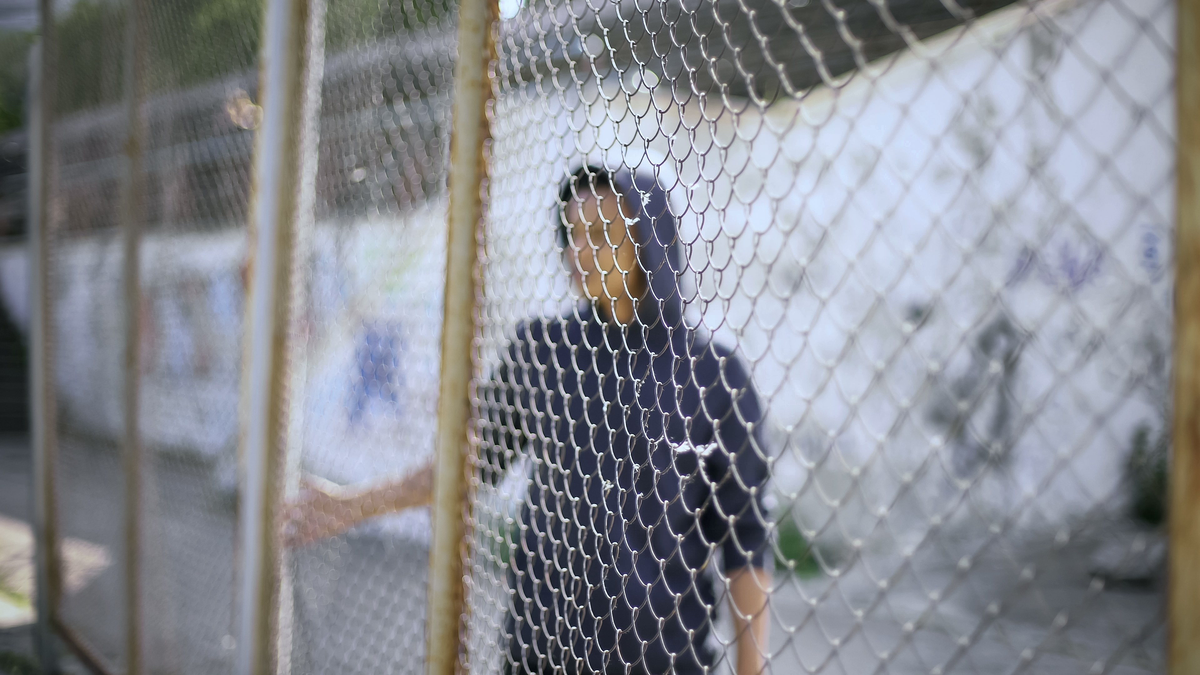 man behind fence