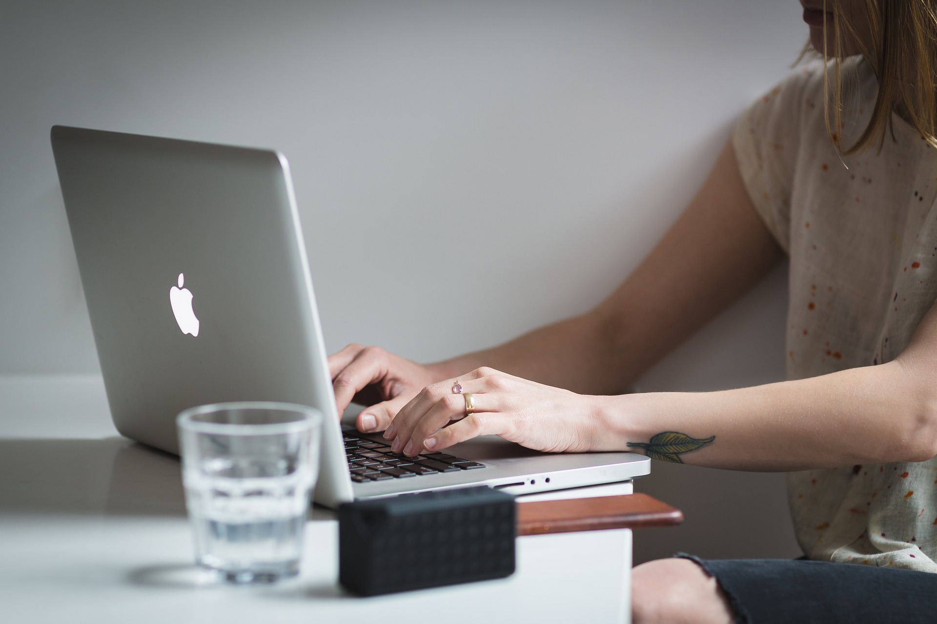 Woman with hands on computer