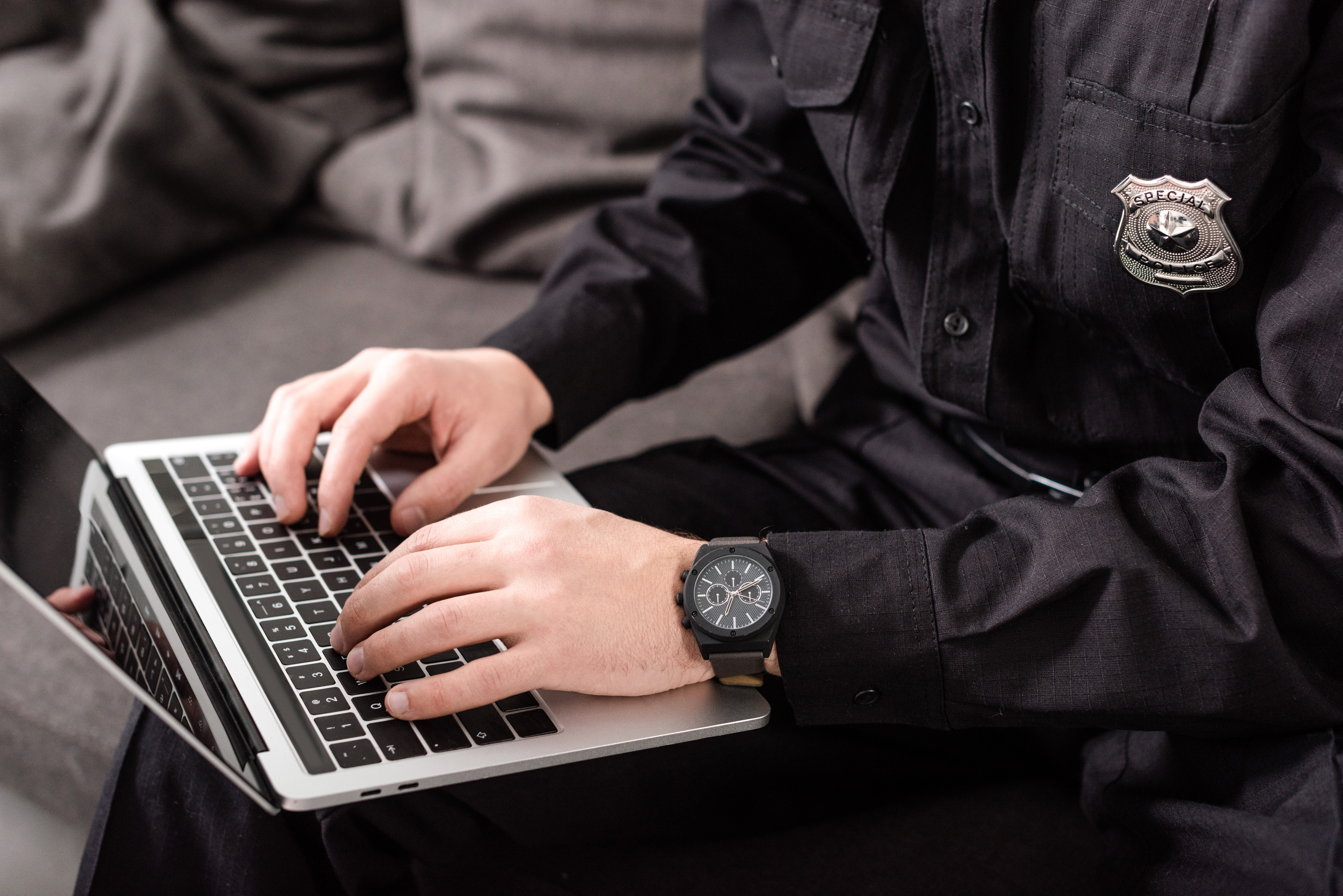 a police officer searches on a keyboard