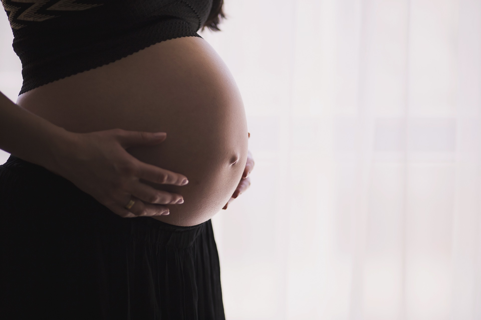 Pregnant woman with hands on her stomach