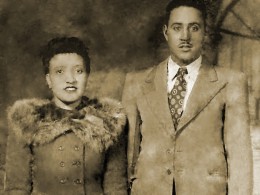 Portrait of Henrietta Lacks in a coat with a male partner, David. wearing a suit.