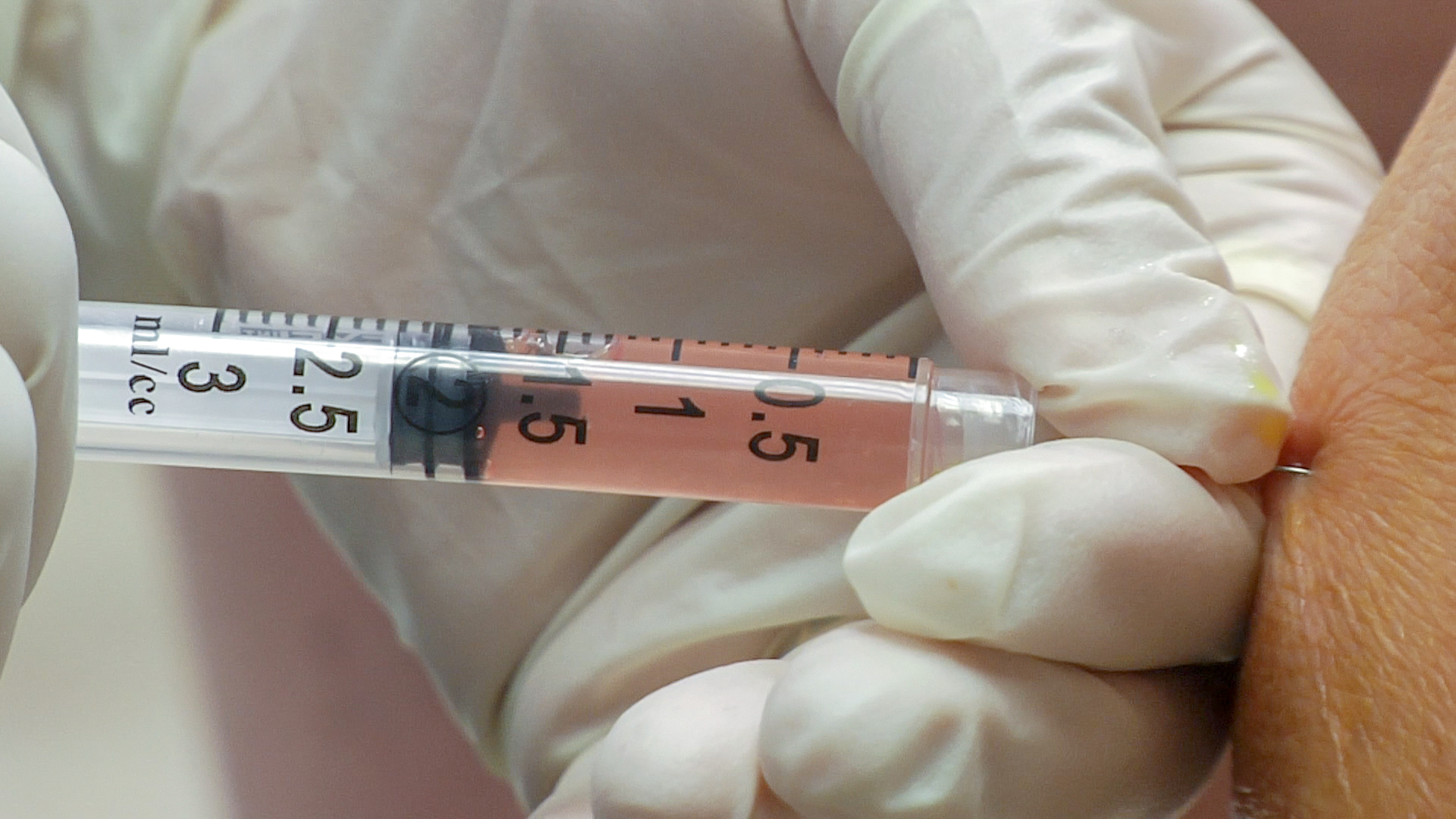 syringe filled with pink liquid