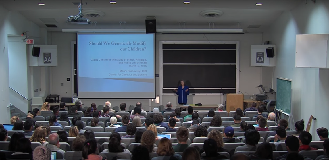 Marcy presents in front of full of lecture hall full of students