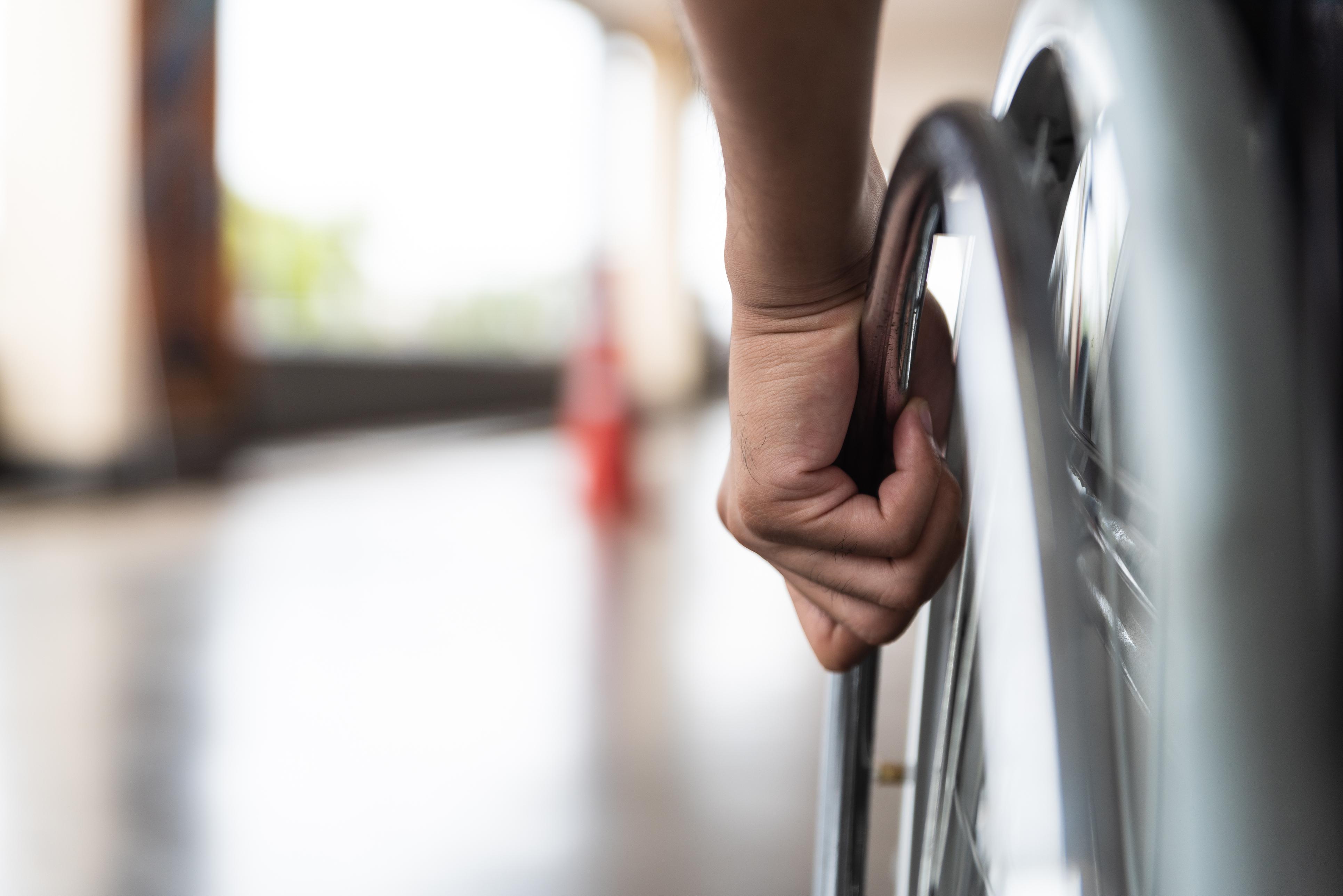 person pushing their own wheelchair