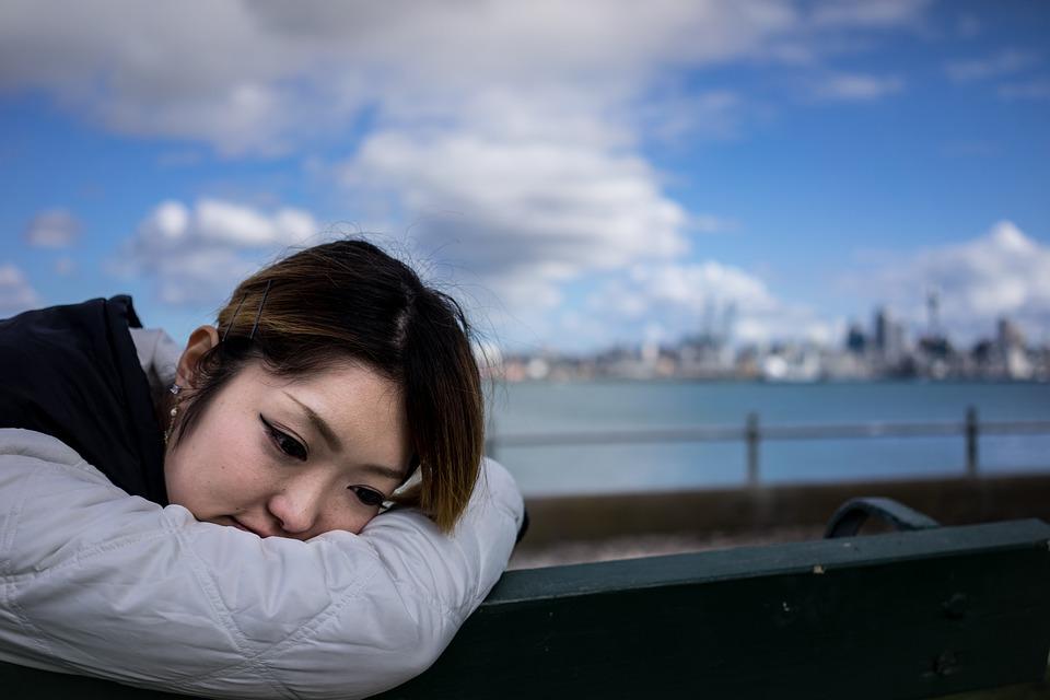 Sad woman resting her head on her arm