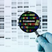 A magnifying glass revealing the human genome from a DNA sequence