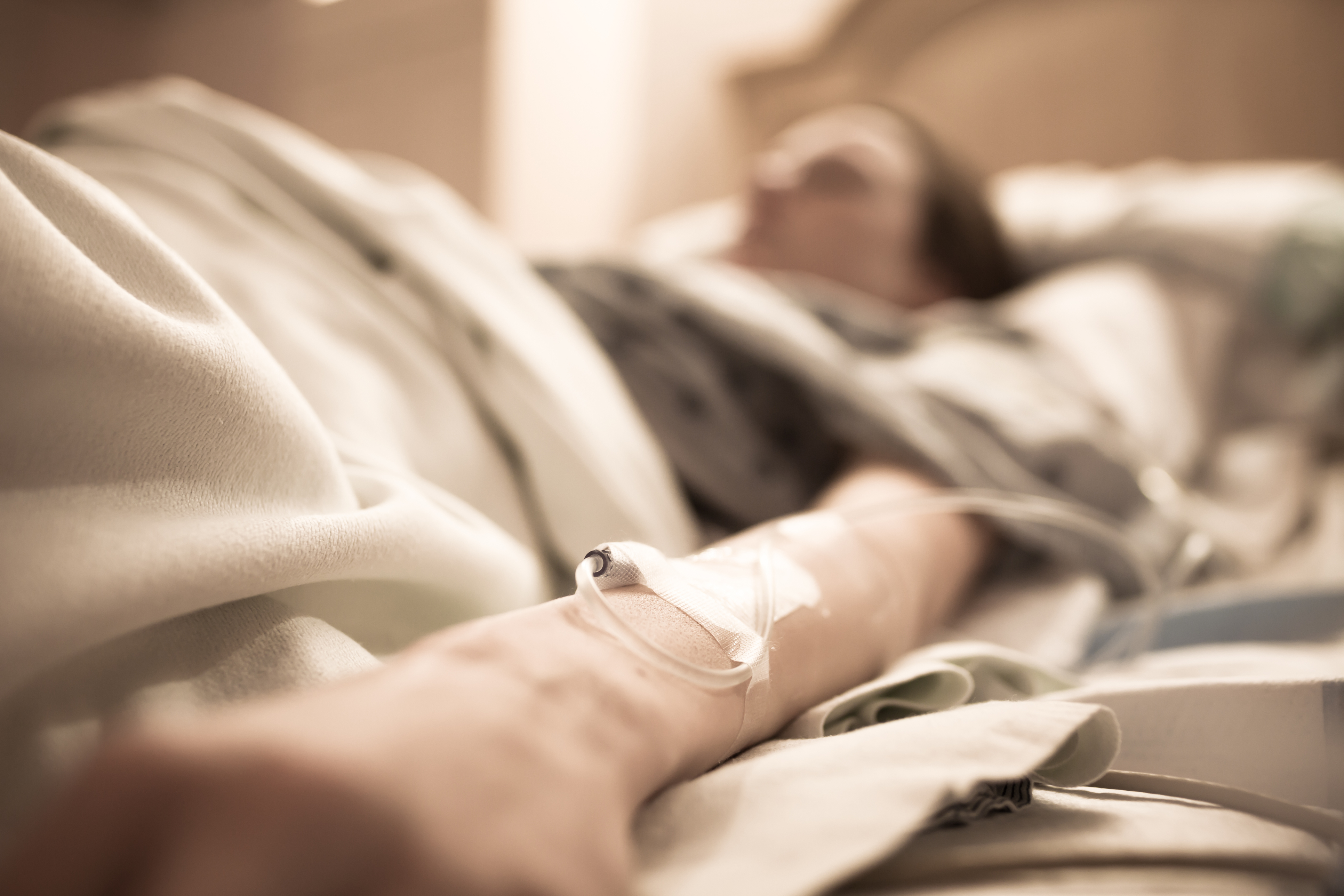 Woman lying in hospital bed